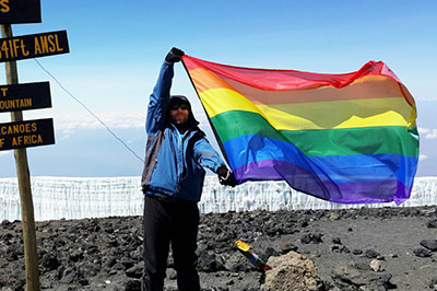 Herbie Aucamp holds the rainbow flag over the roof of Africa